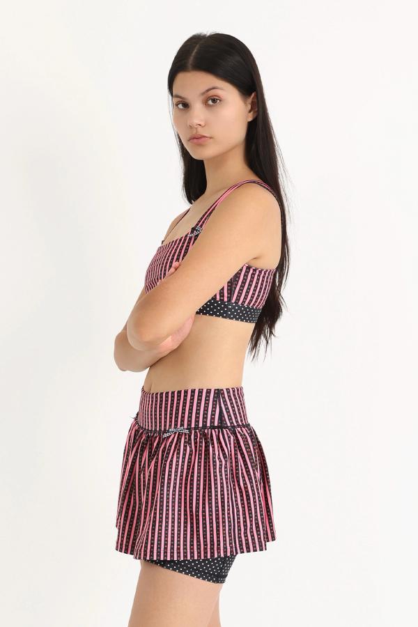 Gathered ruffle exercise skort in a hand-drawn, Pink/Black floral border stripe print with contrast black and white polka dot print and gingham bow details.
