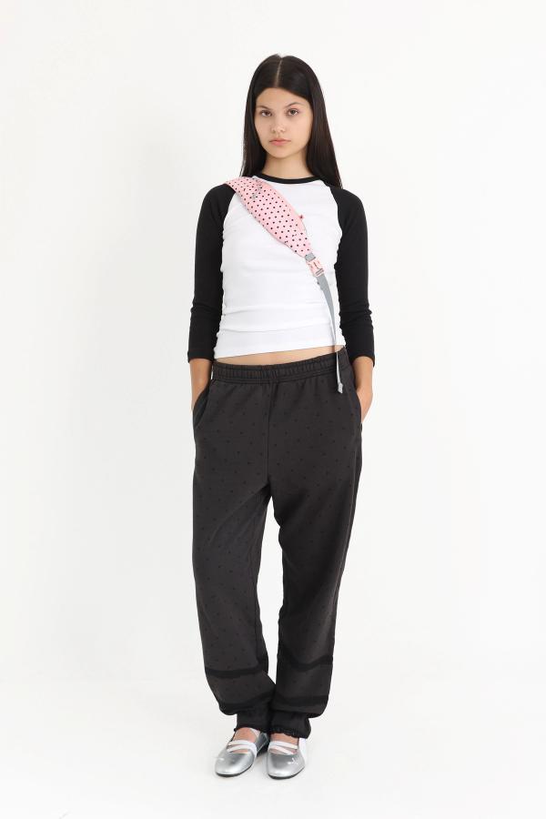 Bloomer-style sweatpants in washed Black with tonal black polka dot print and black lace details at the leg openings.