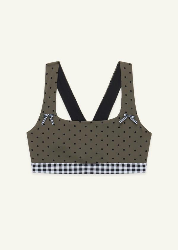 Front view of the medium-support Coco Sports Bra in an Olive Polka Dot print, gingham elastic band and ginghams bows at straps.