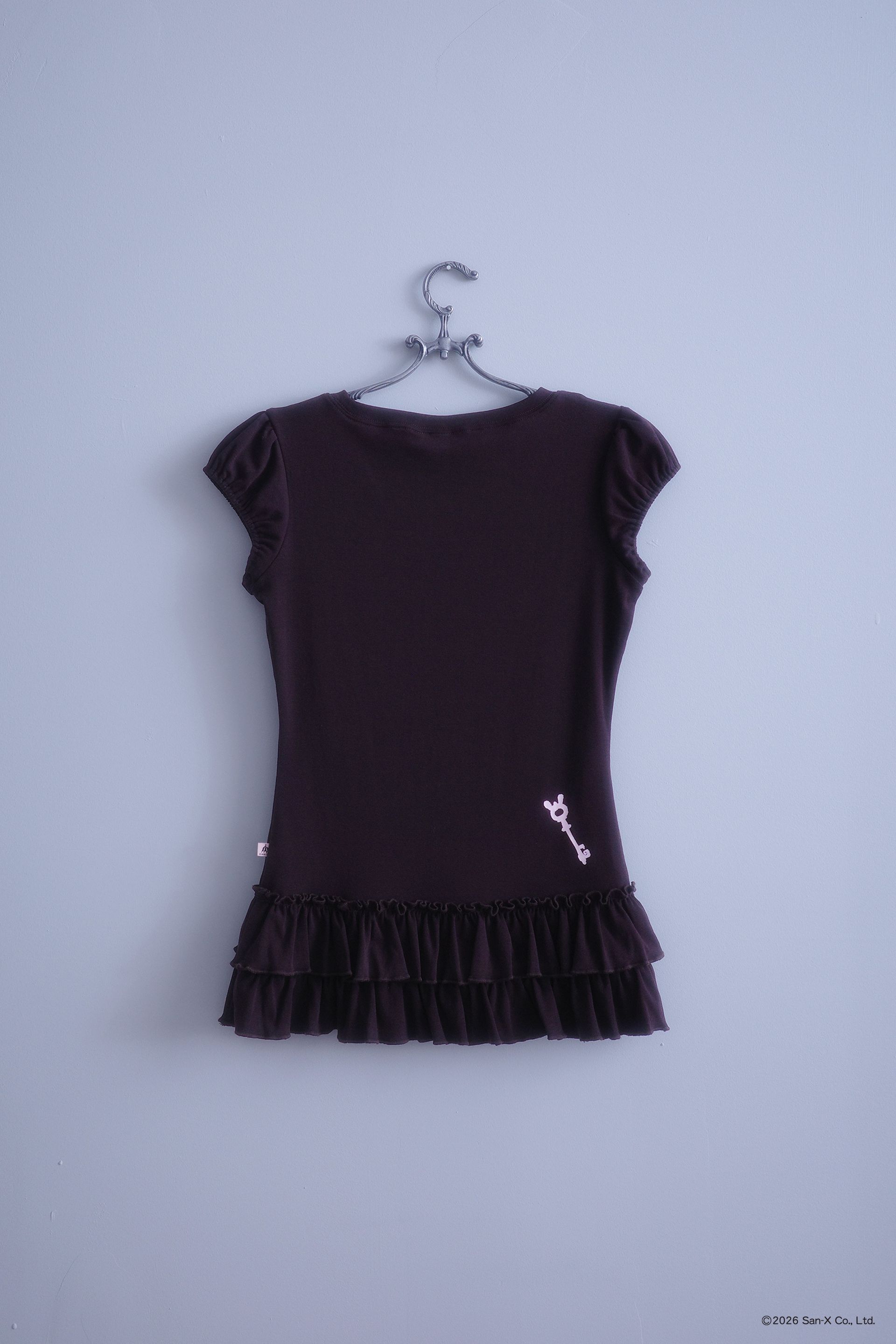 Flat image the back of the Sweets top. Short sleeve, brown, ruffle hem top with a screenprinted baby pink key on the bottom right.