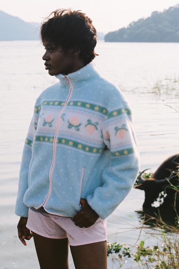 Hiking to a lake in the Blue fluffy jacquard knit sherpa jacket in a choco strawberry border motif with binding, zippers and a metal heart shape zipper pull.
