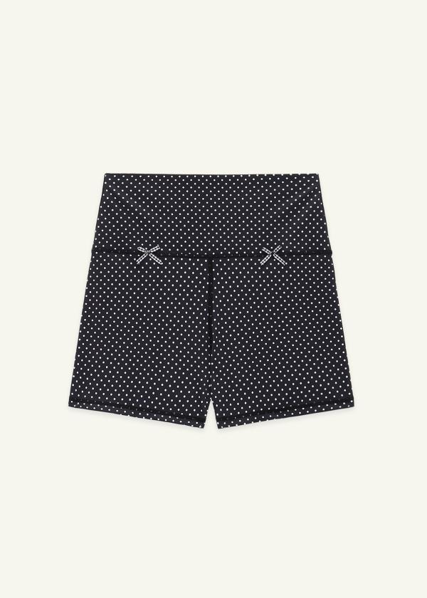 Front view of black and white mini polka dot high waist yoga shorts with gingham bow details.
