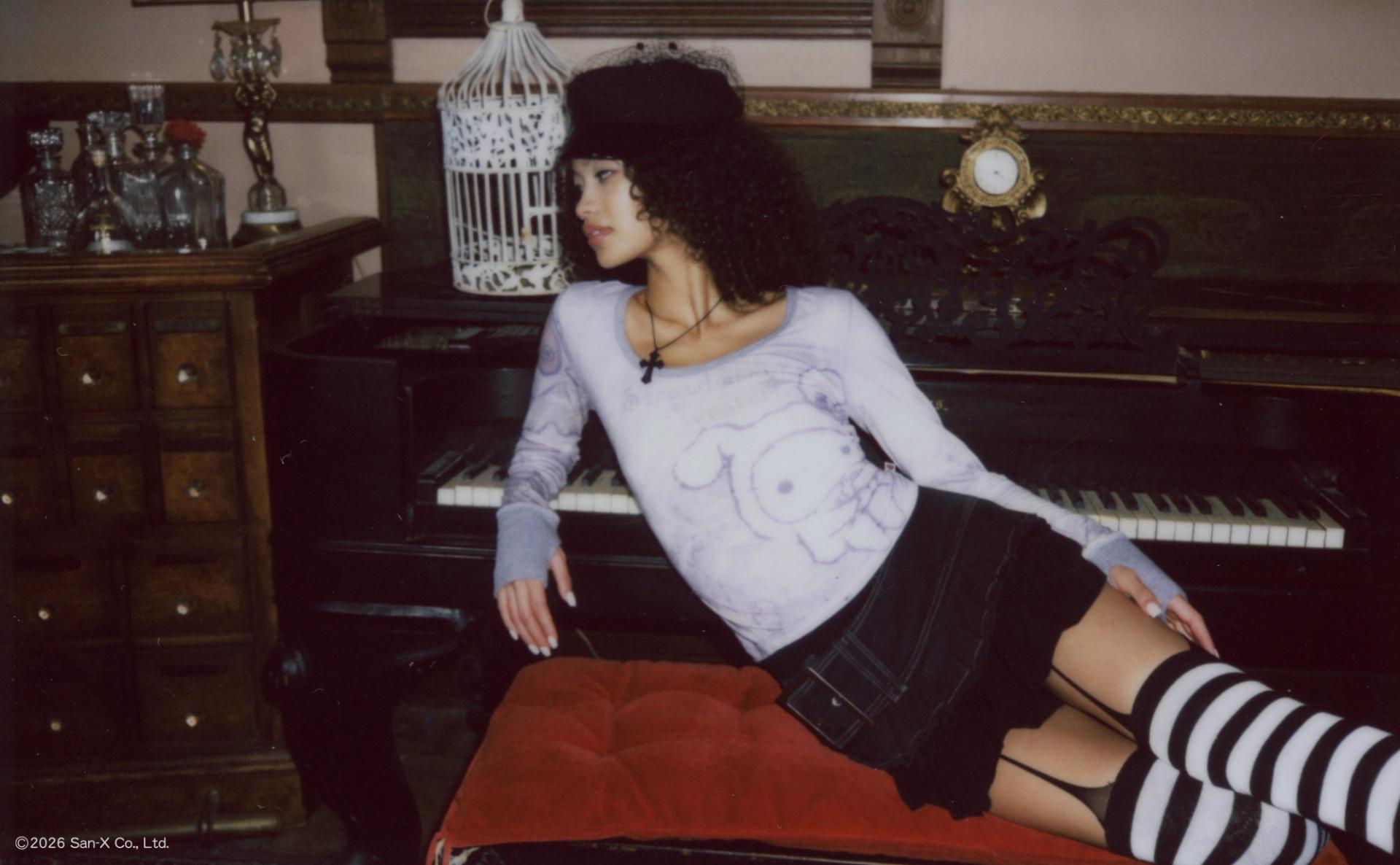 Polaroid photo of a model leaning against a baby grand piano wearing the Sentimental Circus Shappo Top.