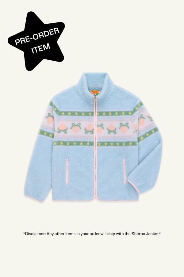 Flat front view of a Blue fluffy jacquard knit sherpa jacket in a choco strawberry border motif with binding, zippers and a metal heart shape zipper pull. Black star in top left corner reads "Pre-order item"