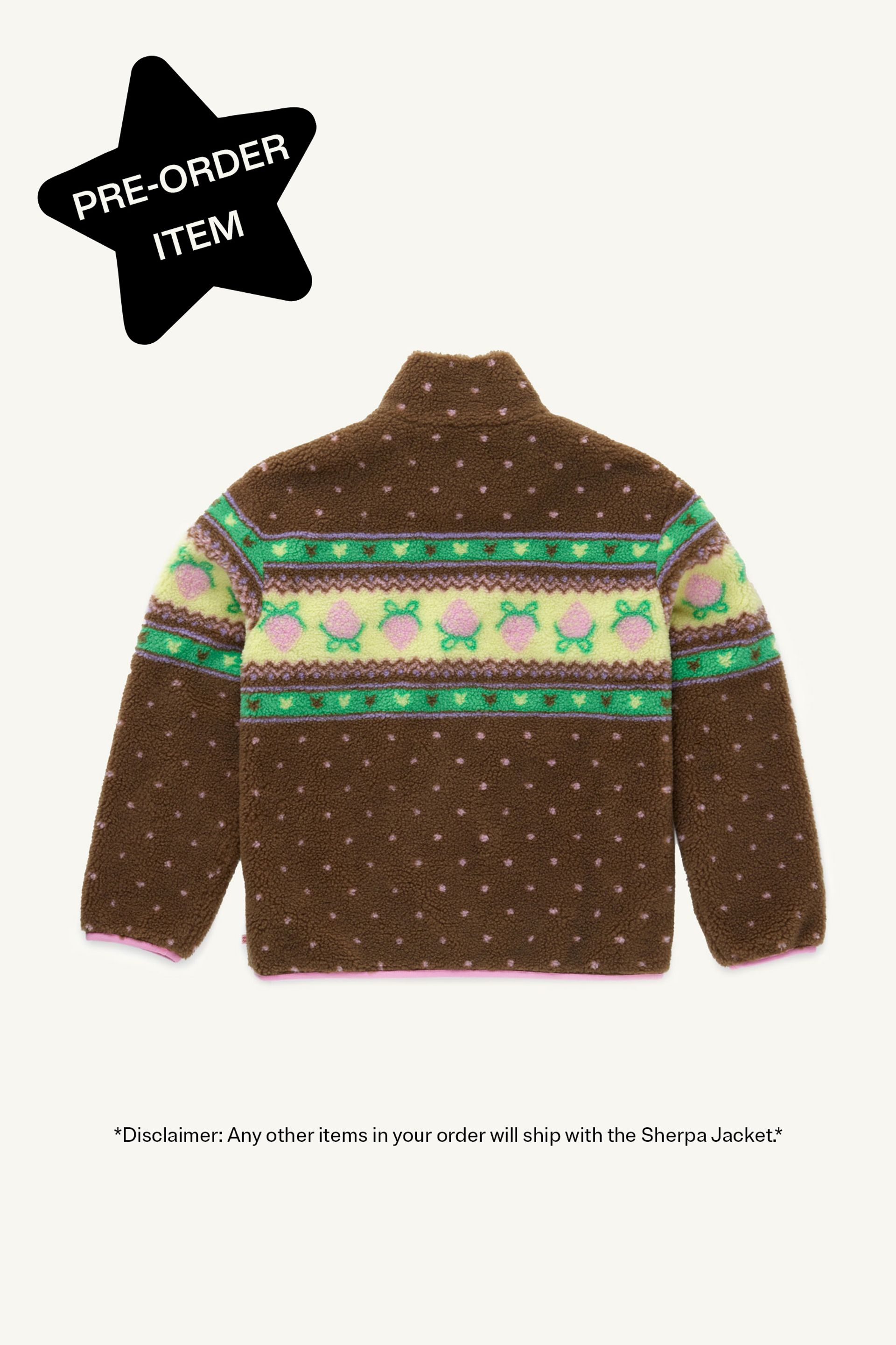 Flat back view of a Brown fluffy jacquard knit sherpa jacket in a choco strawberry border motif with binding, zippers and a metal heart shape zipper pull. Star in top left corner reads "Pre-order item"