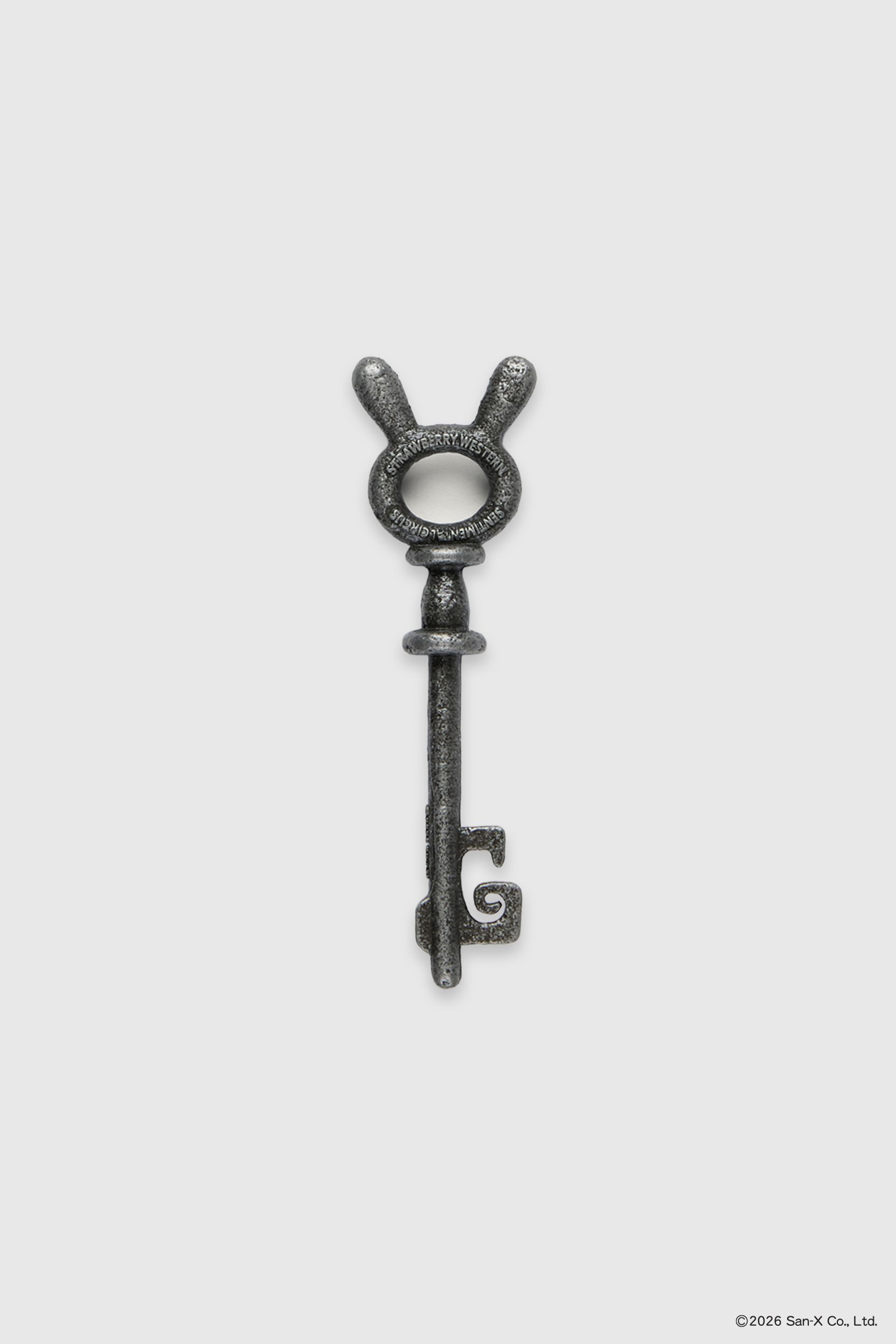 Close up flat image of a beautiful and heavy Sentimental Circus skeleton key. These bunny head keys were brought to life from 2D in a cast iron texture featuring the Sentimental Circus and Strawberry Western logos on both sides. 