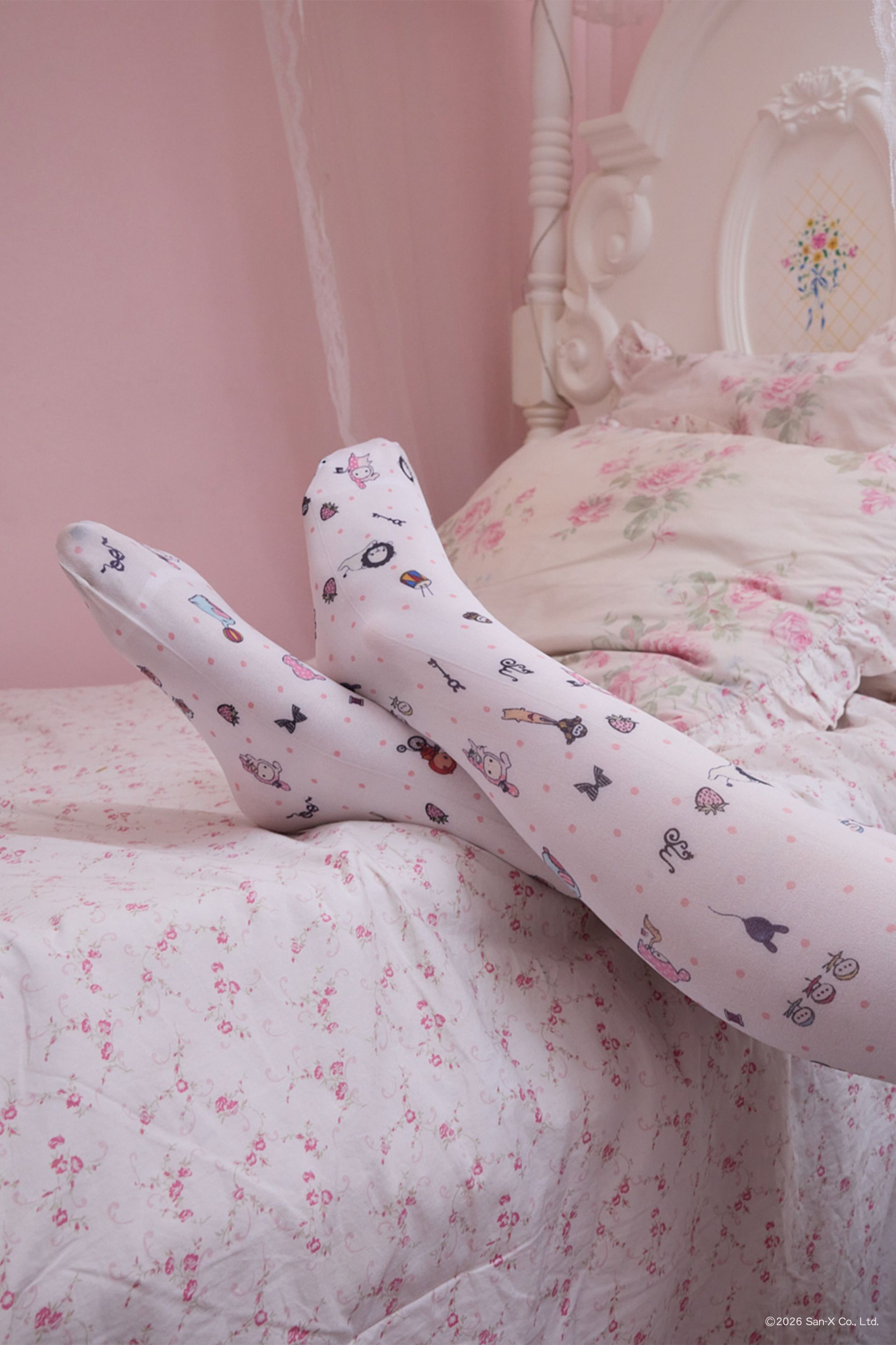 Close up Image of woman with legs on the bed wearing Printed tights with beloved characters and trinkets of Sentimental Circus scattered with polka dots into a sweet ditsy print. Pair it with our Sentimental Circus Bralette! The perfect layering piece for the colder months.