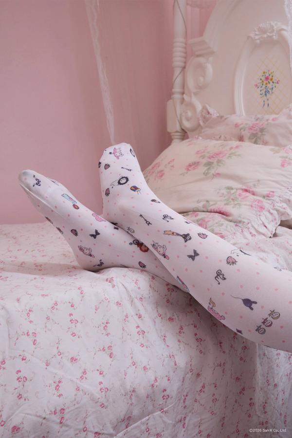 Close up Image of woman with legs on the bed wearing Printed tights with beloved characters and trinkets of Sentimental Circus scattered with polka dots into a sweet ditsy print. Pair it with our Sentimental Circus Bralette! The perfect layering piece for the colder months.