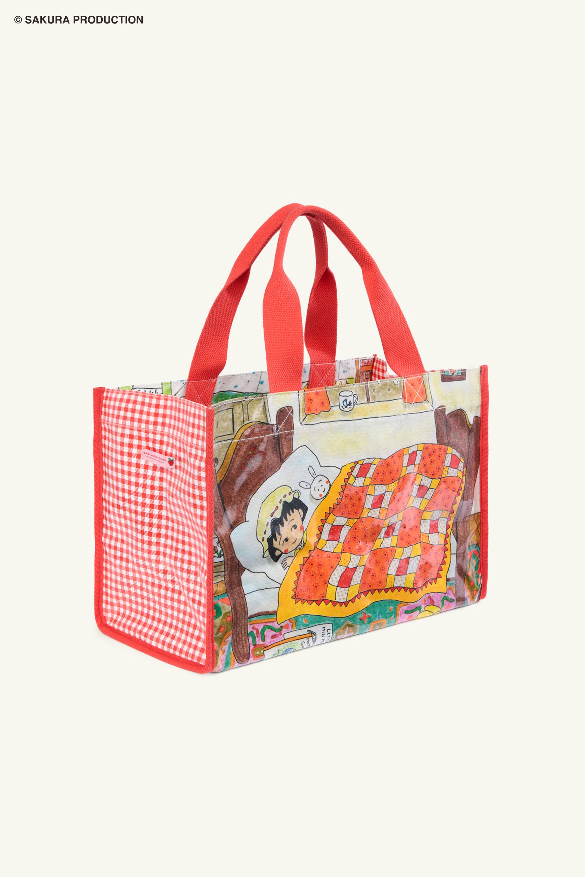 Flat image of Carryall Bag. Plastic tote with image of manga drawing of Chibi Maruko Chan tucked into bed. Side panels red gingham print. Handles and trim are red.