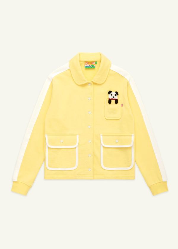 Flat view of butter yellow peter pan collar jacket with heart snaps and a little knit puppy charm that fits in the chest pocket.