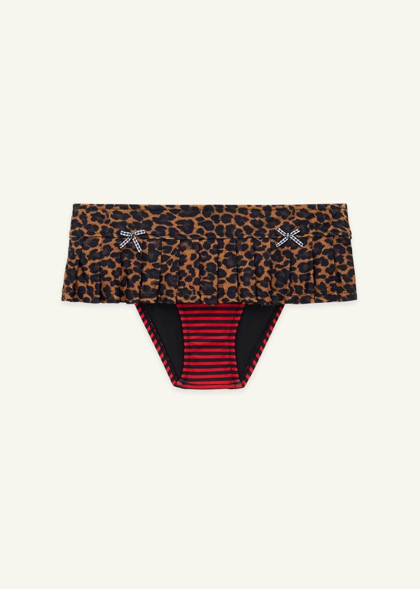 Front view flat lay of micro skirt bikini in leopard print with red and black striped attached bottoms and gingham bows at waist.