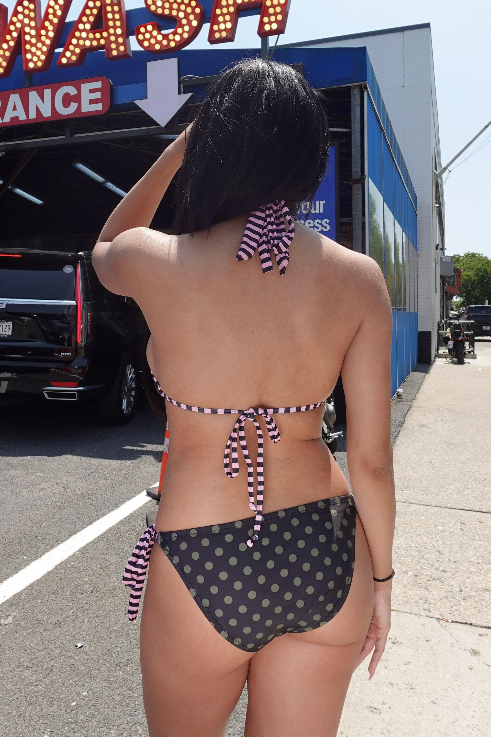 Camo print halter bikini top with striped binding and ties.