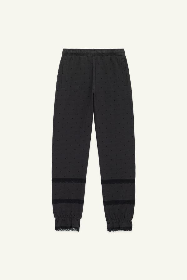 Flat front view of bloomer-style sweatpants in washed black with tonal black polka dot print and black lace details at the leg openings.