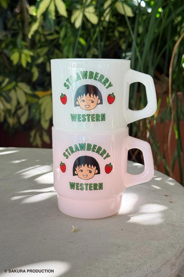 Stacked Pink and Cloud Chibi Maruko Chan Milky Mug. The front reads Strawberry Western in green lettering. In the middle is Chibi Maruko-chan's face surrounded by two strawberries.