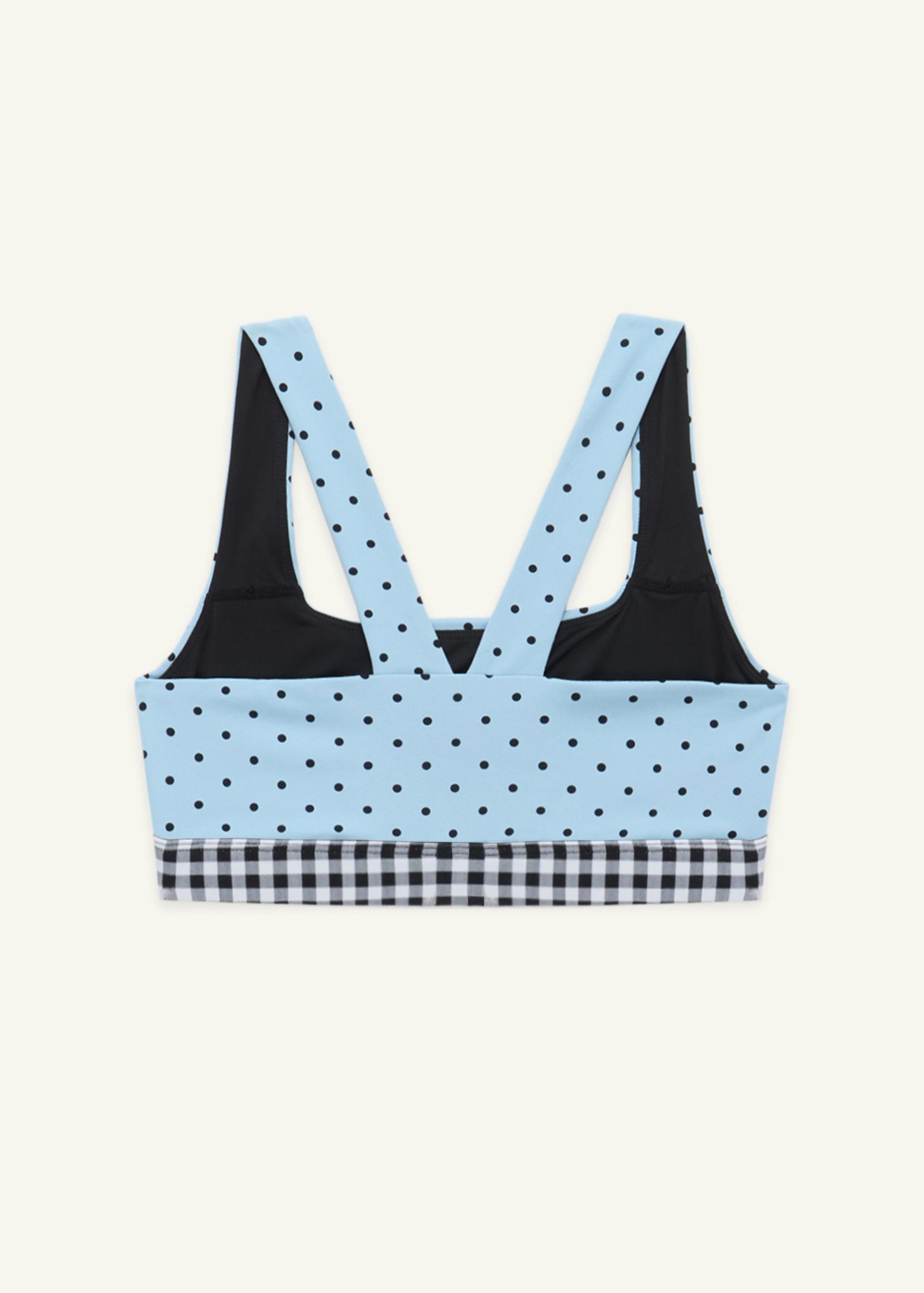 Back view of the medium-support Coco Sports Bra in Blue Polka Dot print with a gingham elastic band and gingham bows on the straps.