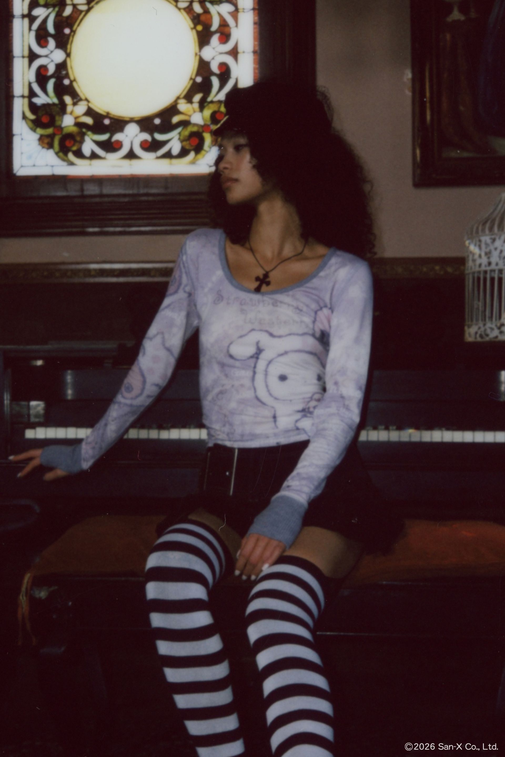 Polaroid photo of a model leaning against a baby grand piano wearing the Sentimental Circus Shappo Top.