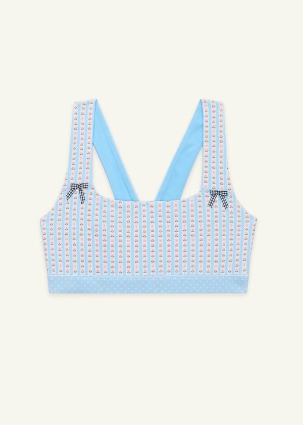 Front view of medium-support Coco Sports Bra silhouette featuring a hand-drawn, floral border stripe print in Blue/Ivory with contrast polka dot print elastic band and gingham bow details.