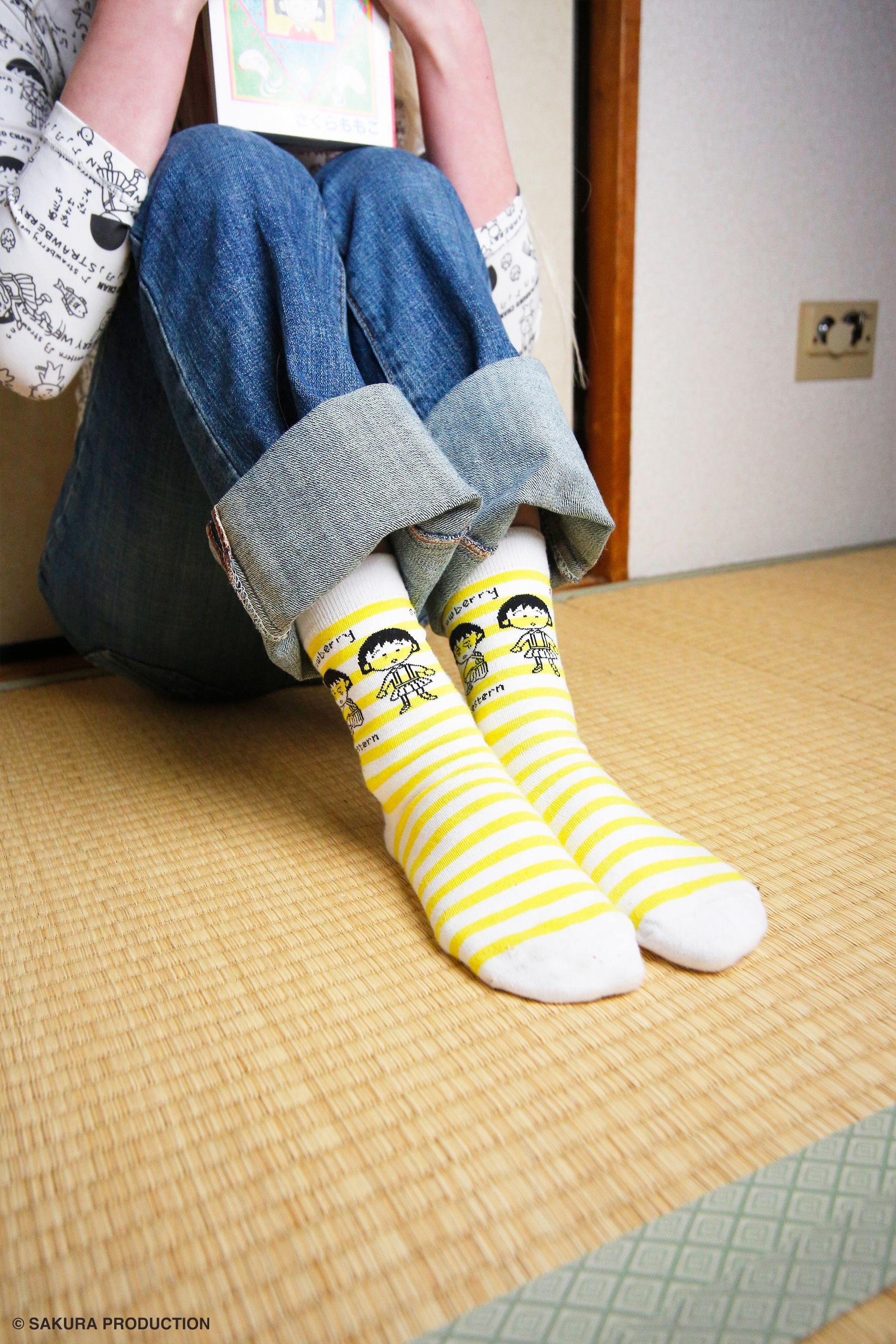 Close up image of a girl wearing the yellow and white stripe sock.