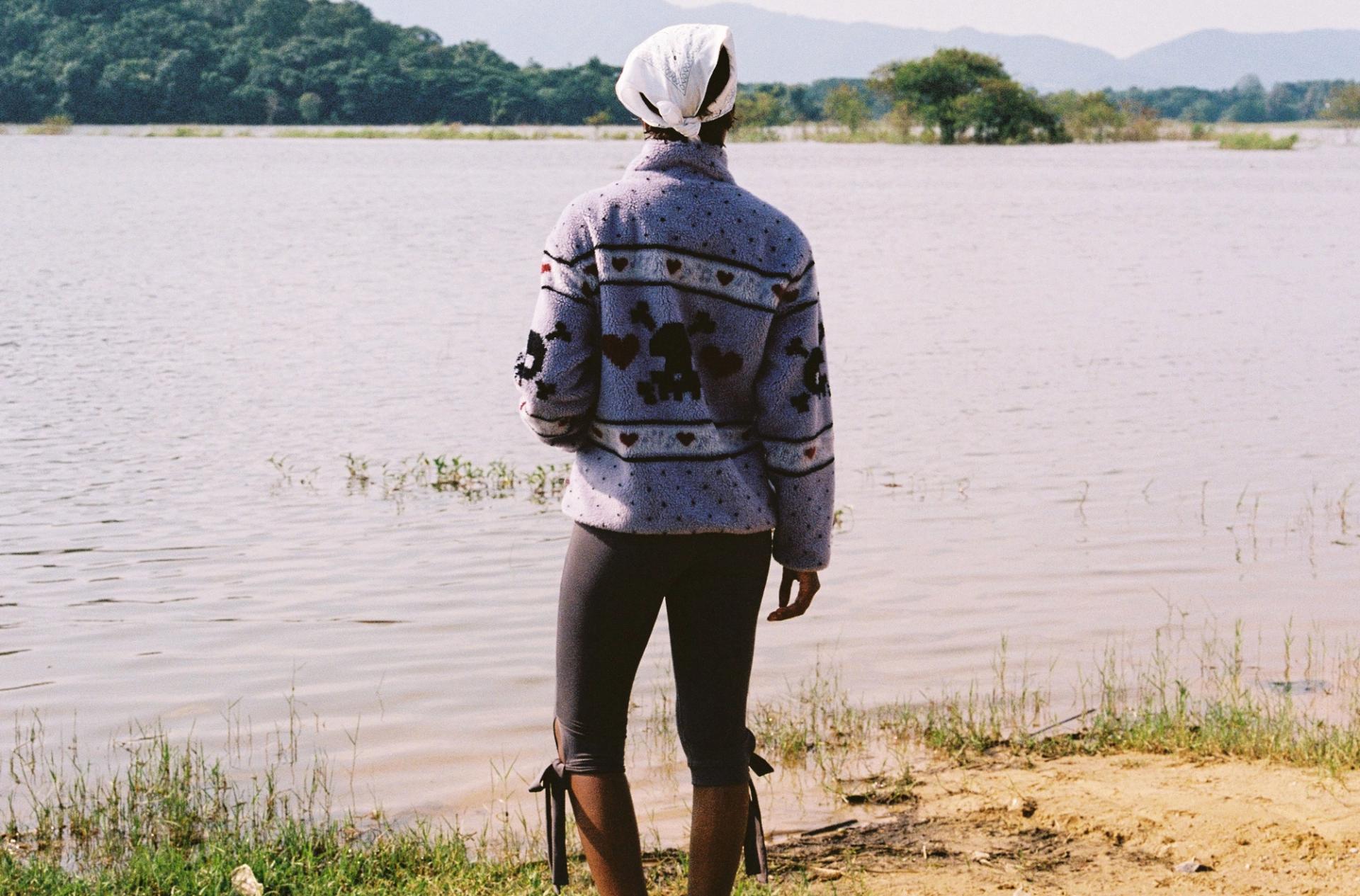 Kawaii dusty purple sherpa fleece jacket in a skull and polka dot pattern worn on a hike to a pond in Thailand.