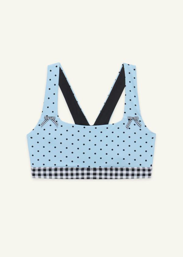 Front view of the medium-support Coco Sports Bra in a Blue Polka Dot print, gingham elastic band and ginghams bows at straps.