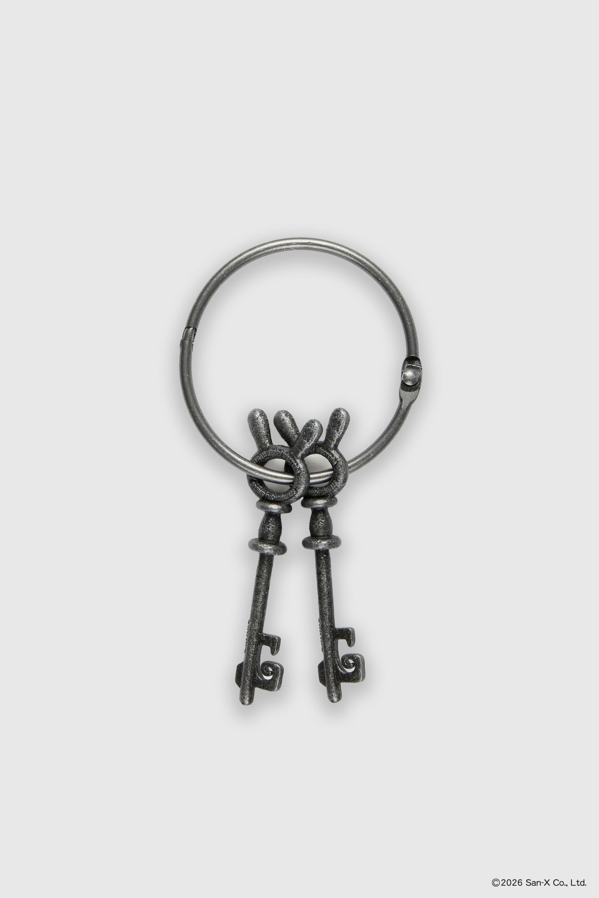 Flat image of a pair of two beautiful and heavy Sentimental Circus skeleton keys on a large hinged, jailer ring. These bunny head keys were brought to life from 2D in a cast iron texture featuring the Sentimental Circus and Strawberry Western logos on both sides. 