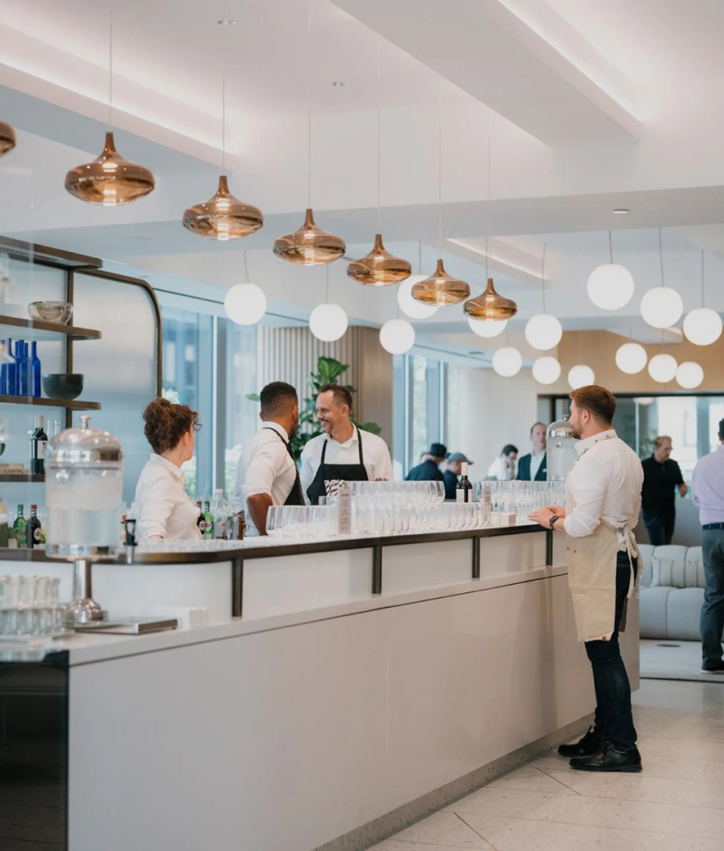 Modern Café & Cocktail Bar featuring a lengthy counter and the Well& by Durst logo on the wall during a corporate event