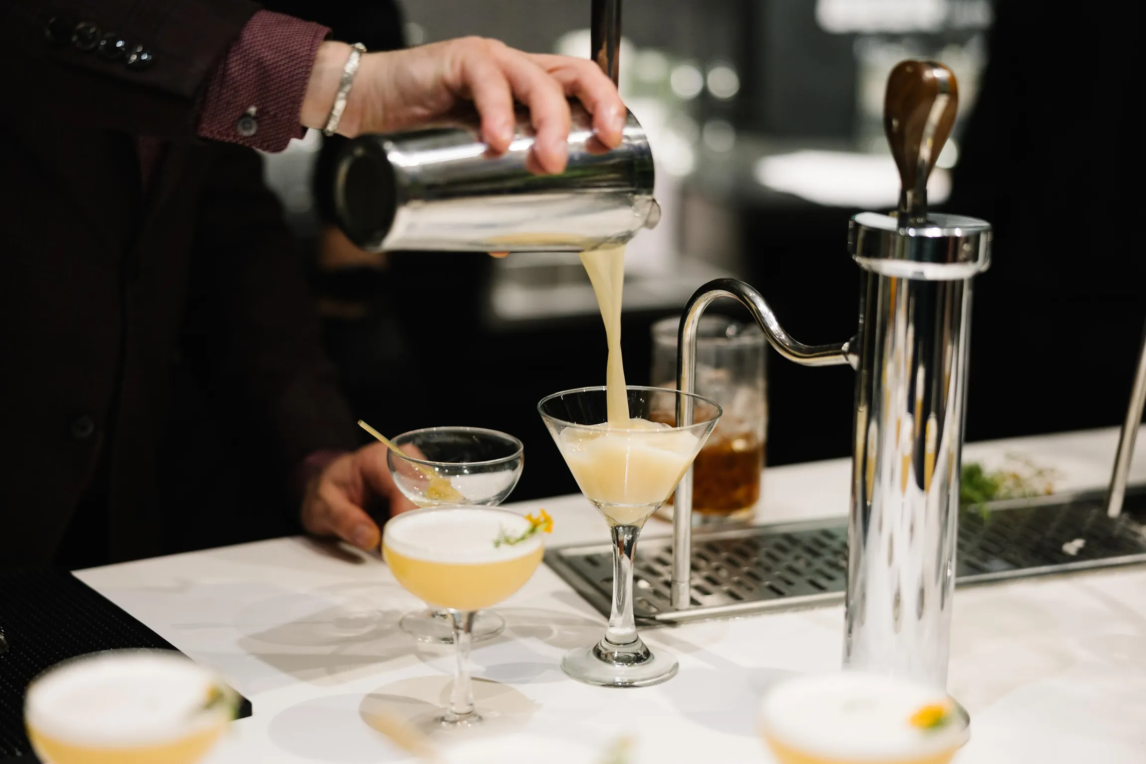 Bartender making craft cocktails at The Green