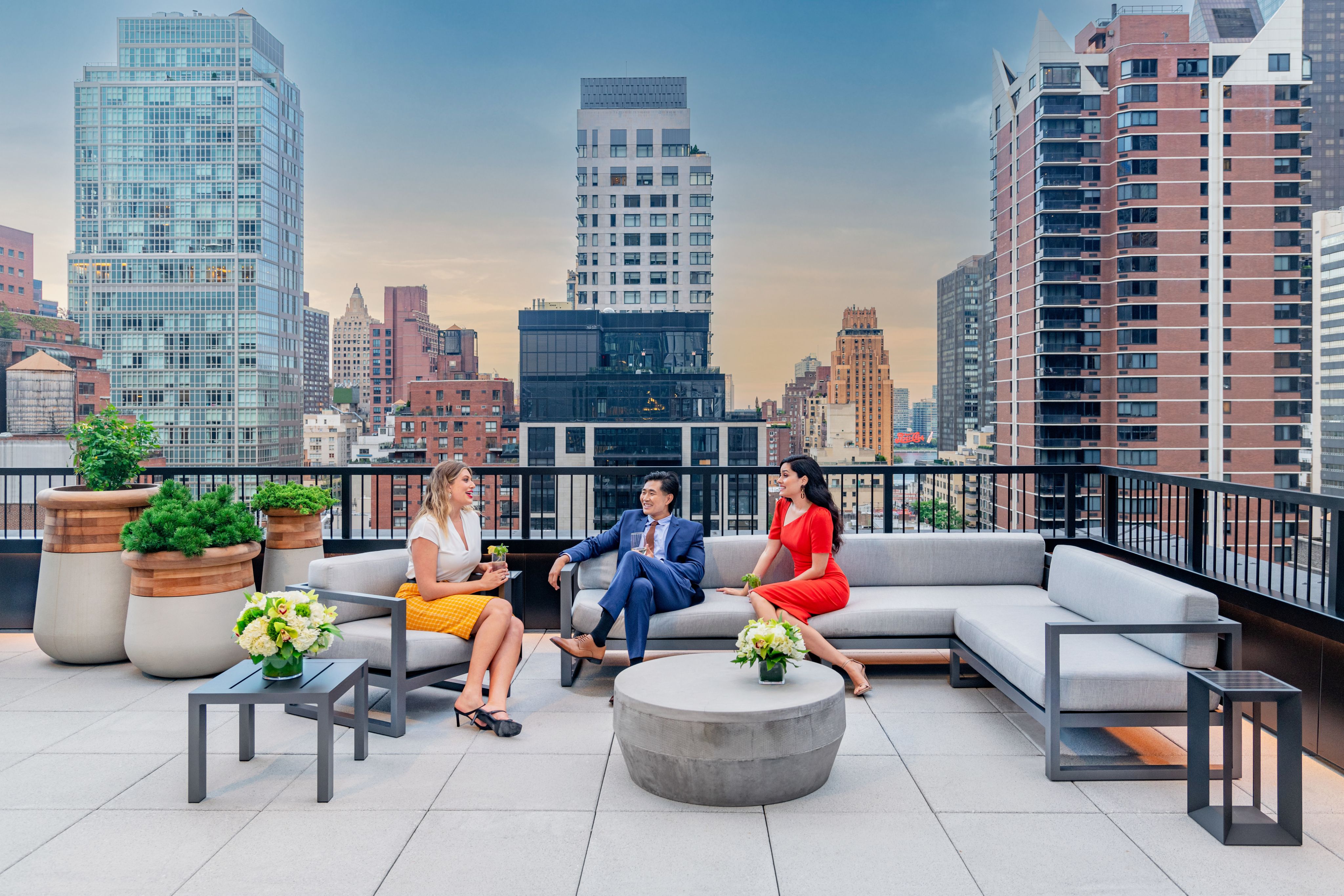 A group of friends enjoying the 12th floor terrace of 825 Third Avenue's modern building