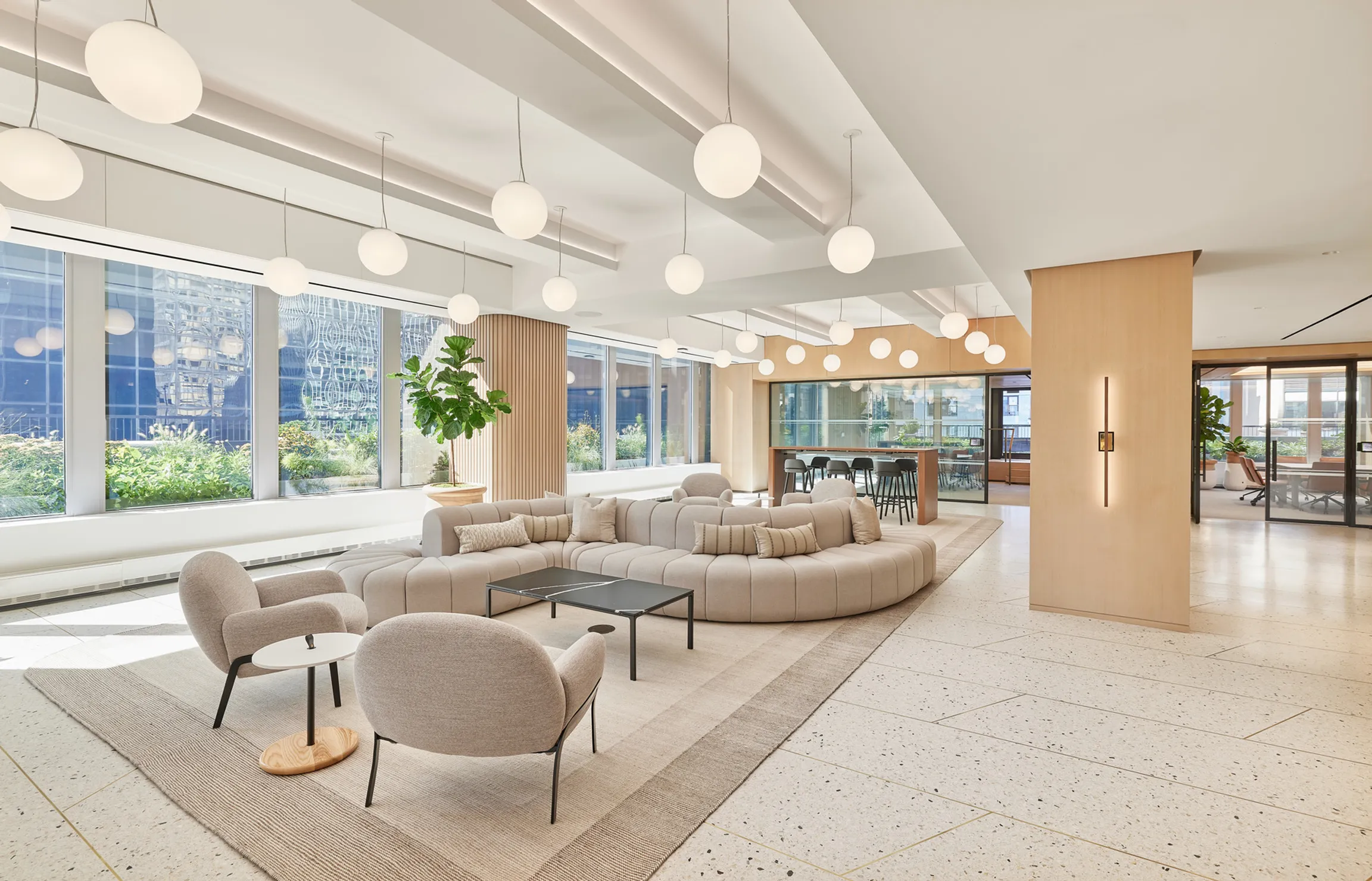 A contemporary office lounge with a prominent circular couch, creating a stylish atmosphere
