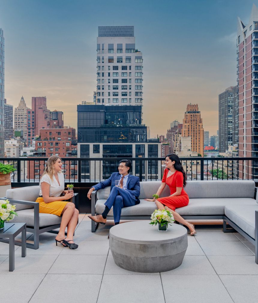 A group of friends enjoying the 12th floor terrace of 825 Third Avenue's modern building