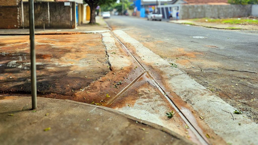 Operários constroem sarjetões em rua de Araçatuba para melhorar drenagem.