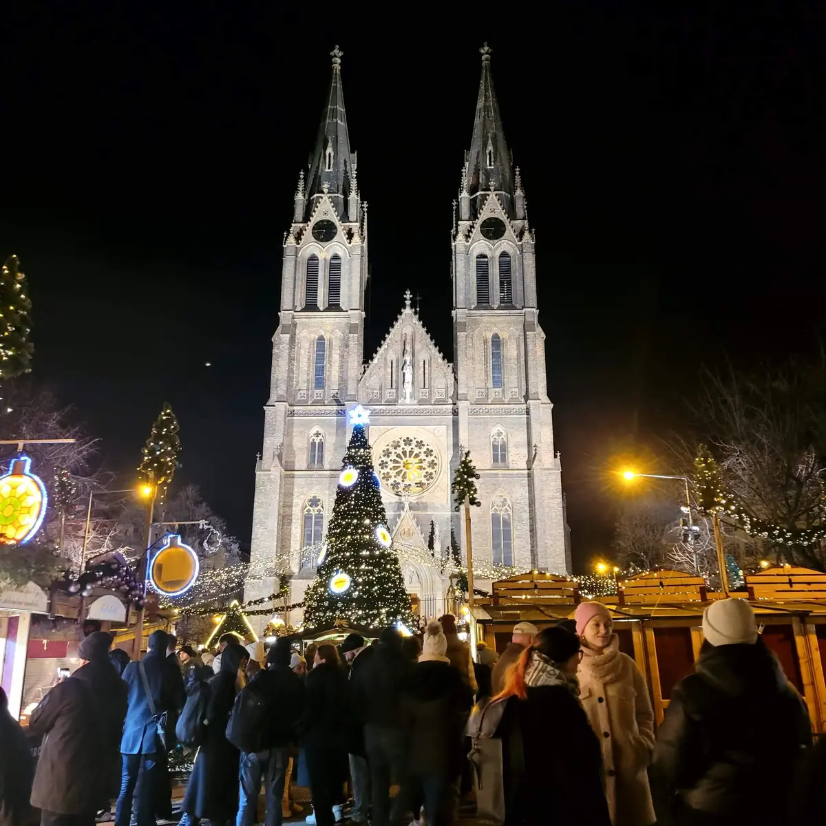Il mercatino di Natale di Náměstí Míru di sera, davanti alla chiesa di Santa Ludmilla illuminata