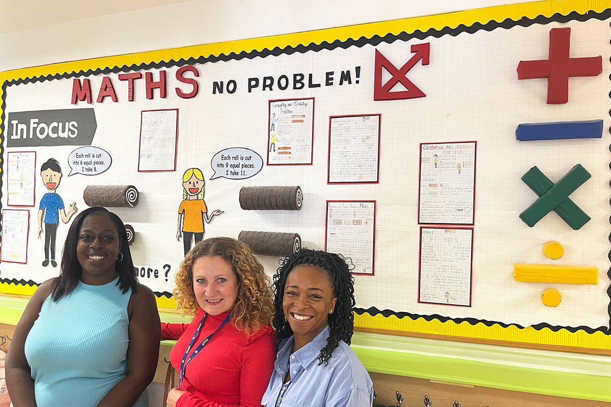 Laurice Prempeh and two other maths teachers in front of a Maths Wall
