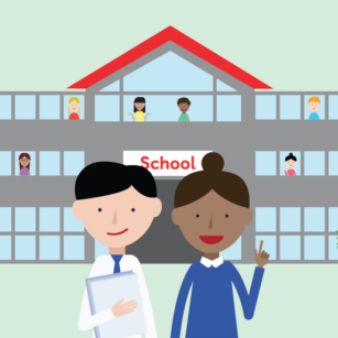 Two teachers standing in front of a school