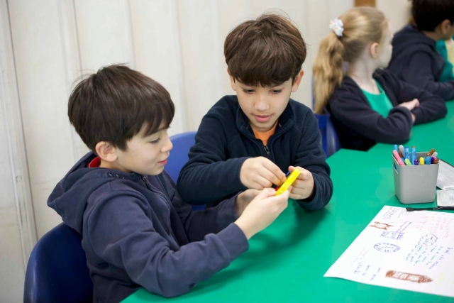 Two primary school pupils doing maths activity together