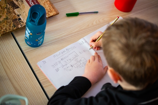 Boy journaling math