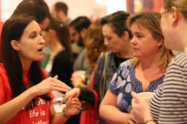 attendees engage in lively conversation and networking during a professional event, fostering connections and idea sharing
