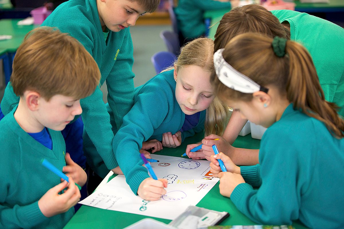Pupils at Muscliff working together on maths work.
