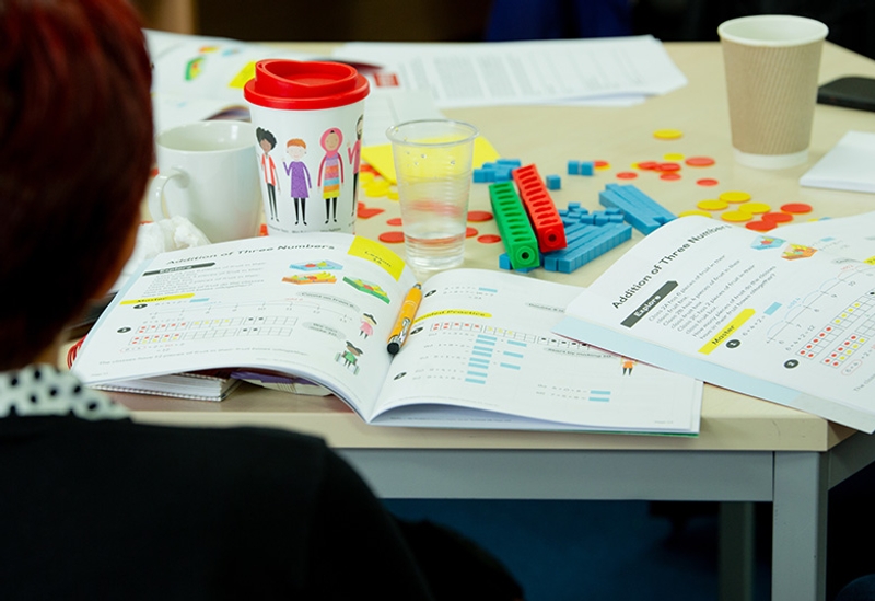Maths — No Problem! textbook and manipulatives on a table