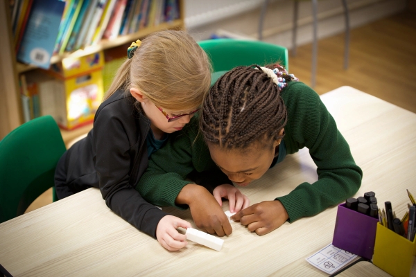 Two girls working together on math.
