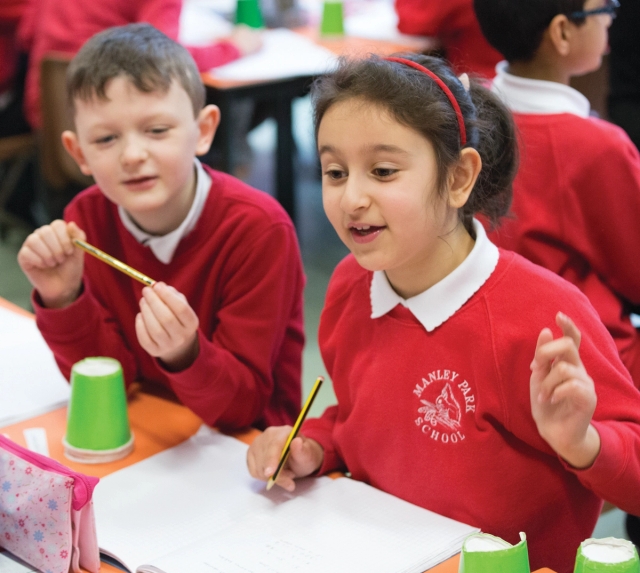 A girl and boy working on their maths journals together.