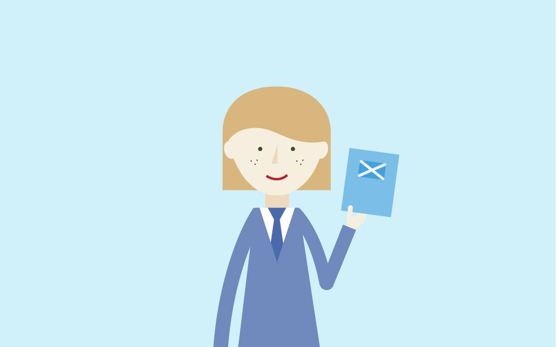 A maths student holding up a book with a Scottish flag on it