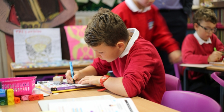 A maths mastery student at Star Primary writing in maths journal.