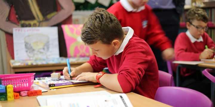 A maths mastery student at Star Primary writing in maths journal.