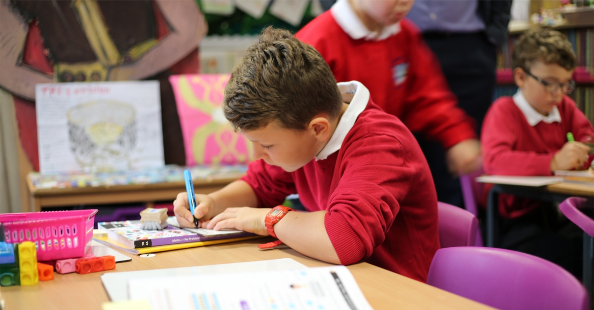 A maths mastery student at Star Primary writing in maths journal.