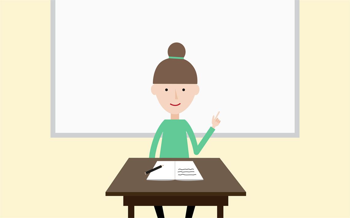 A maths teacher at the front of her class giving a lesson in front of a whiteboard