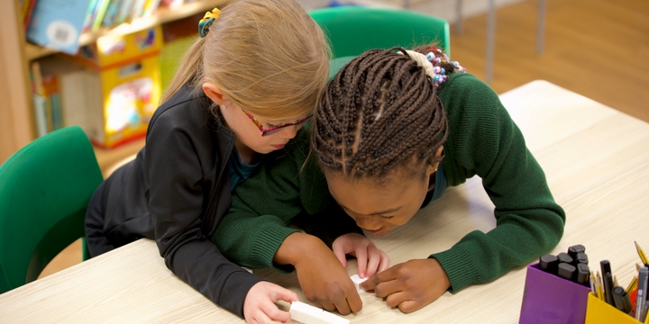 Two pupils working together with materials