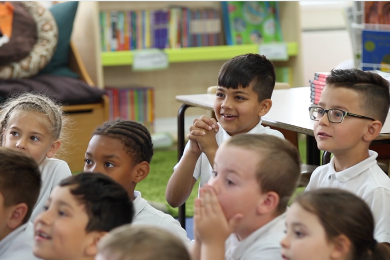 A group of pupils listening and engaged.