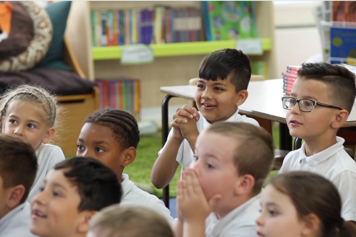 A group of pupils listening and engaged.