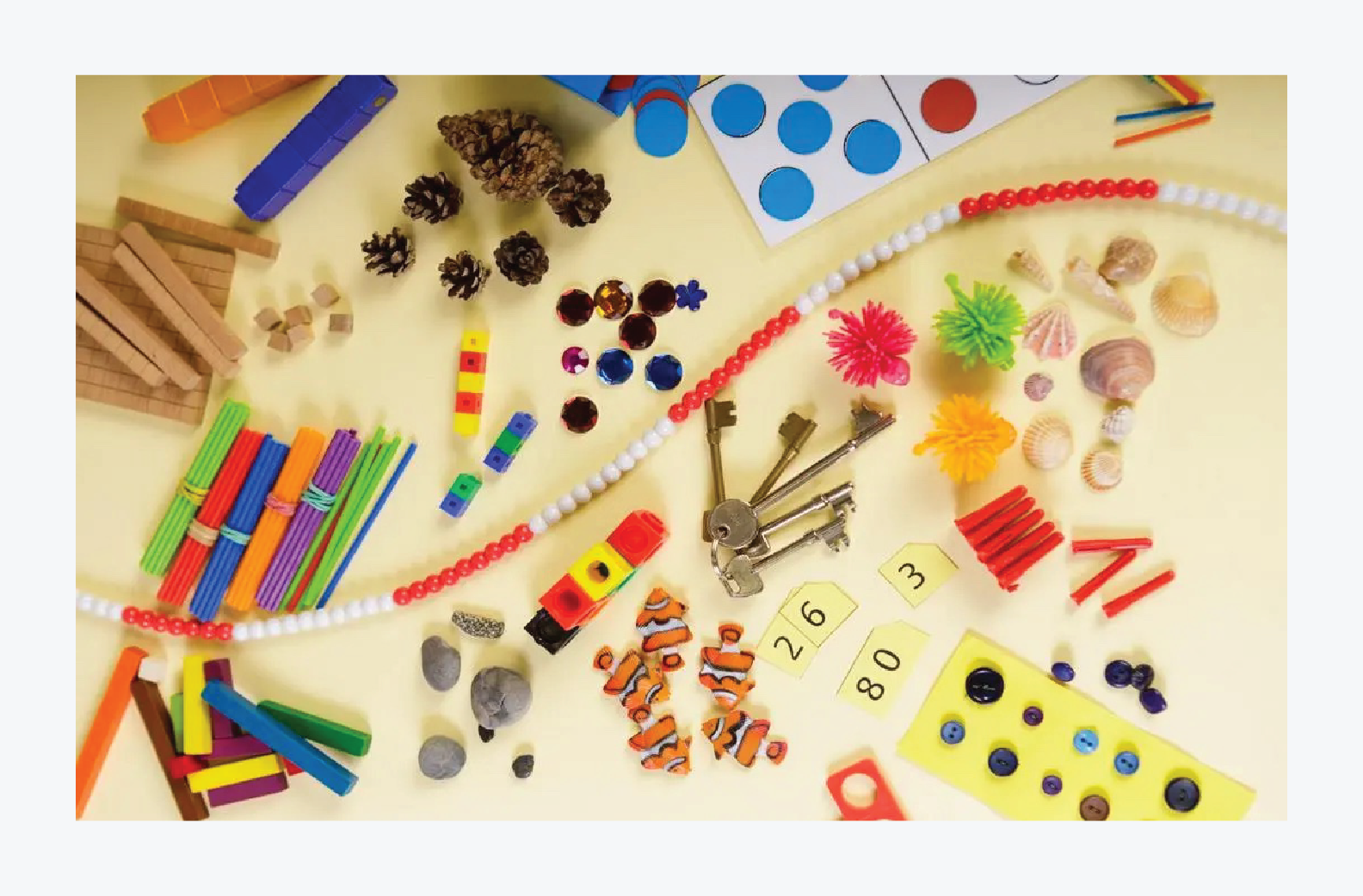 a table strewn with many different sorts of maths manipulatives.